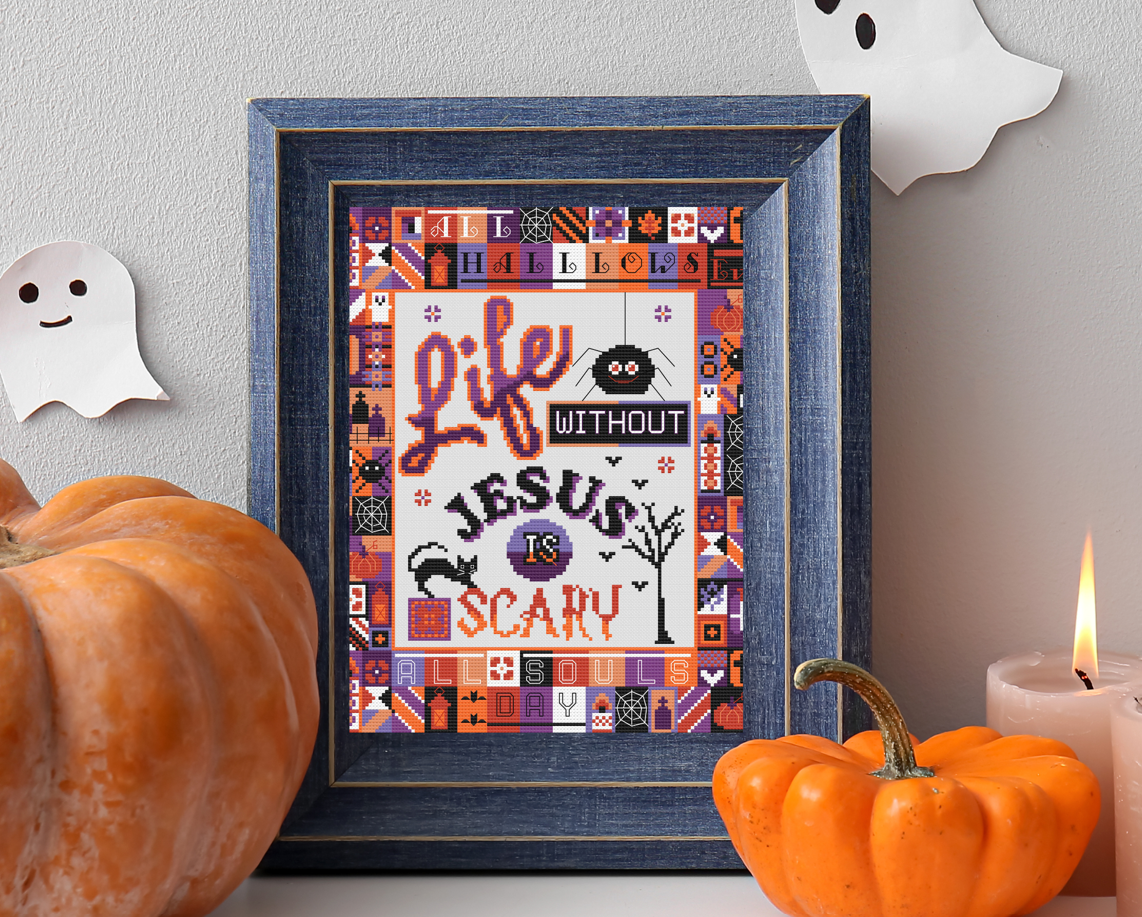 Catholic Halloween Cross Stitch Pattern framed surrounded b y typical Halloween Decor
